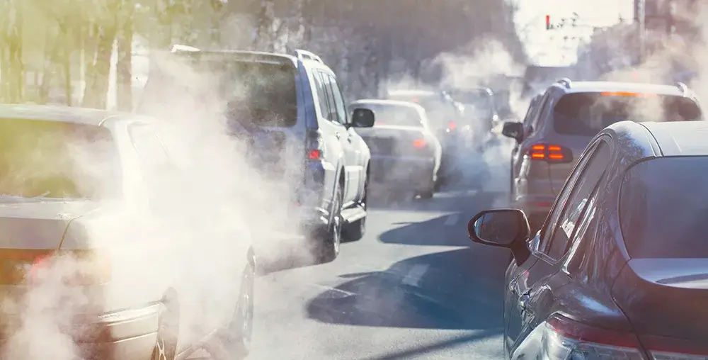 cars in traffic with a lot of emissions coming from cars